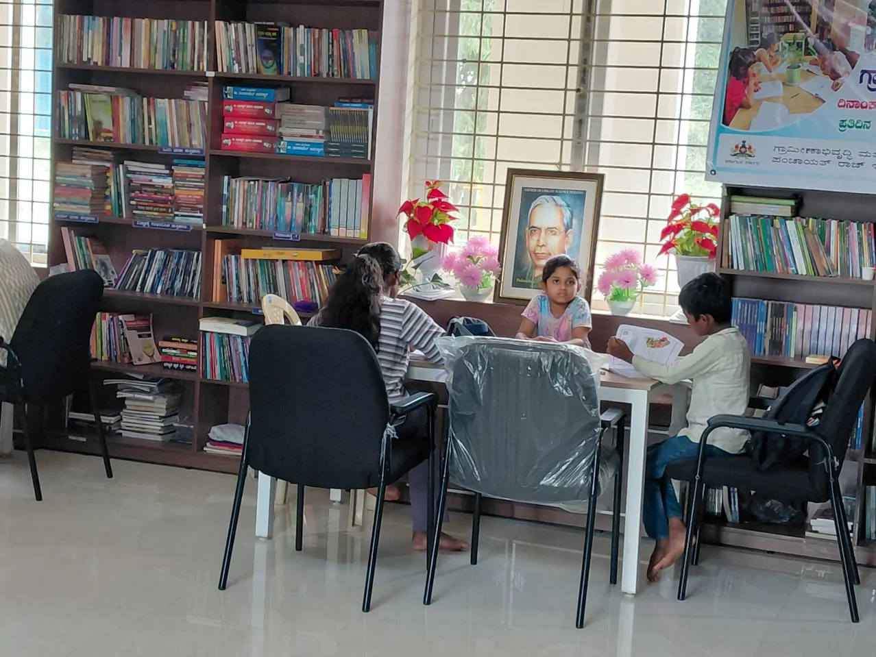 Women and children reading together among the shelves